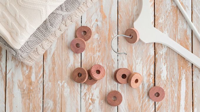 Wooden cedar rings for repelling moths and protect clothing in closets.