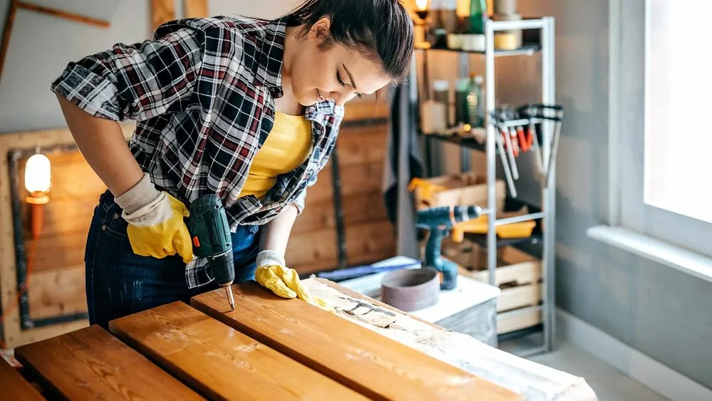 A woman puts together garage shelves.