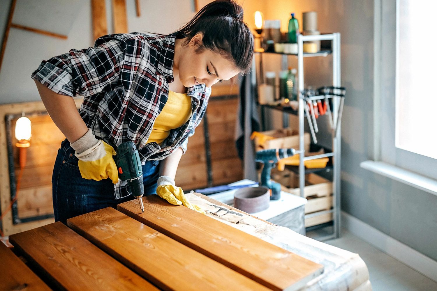 A woman puts together garage shelves.