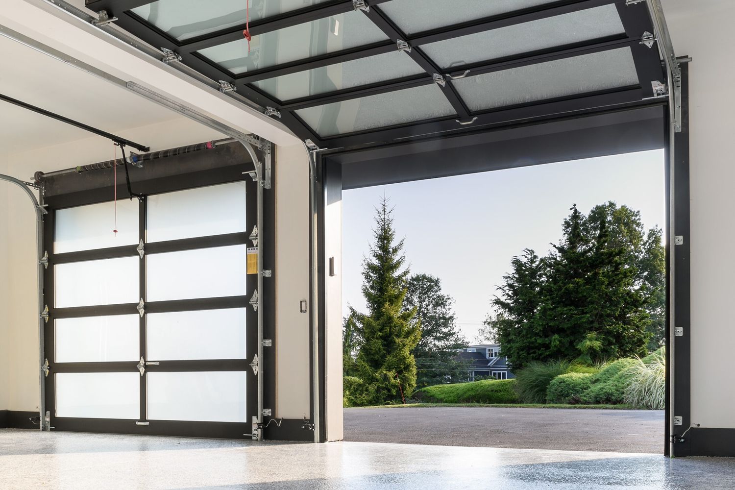 Farmhouse garage doors open after homeowners replace their springs.