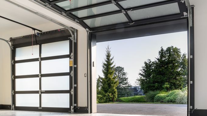 Farmhouse garage doors open after homeowners replace their springs.