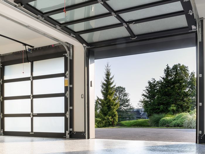 Farmhouse garage doors open after homeowners replace their springs.