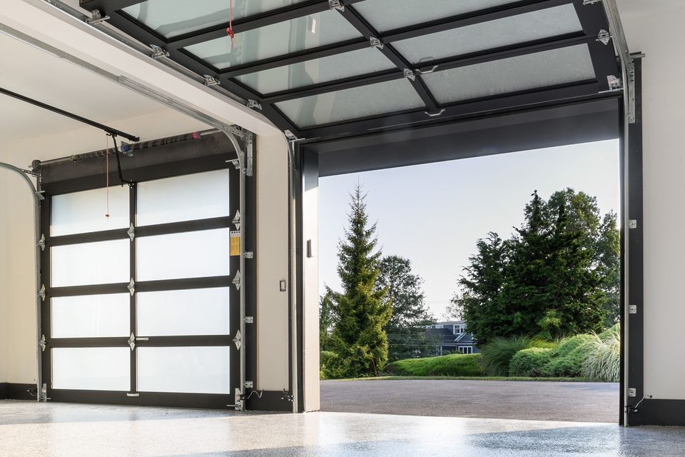 Farmhouse garage doors open after homeowners replace their springs.