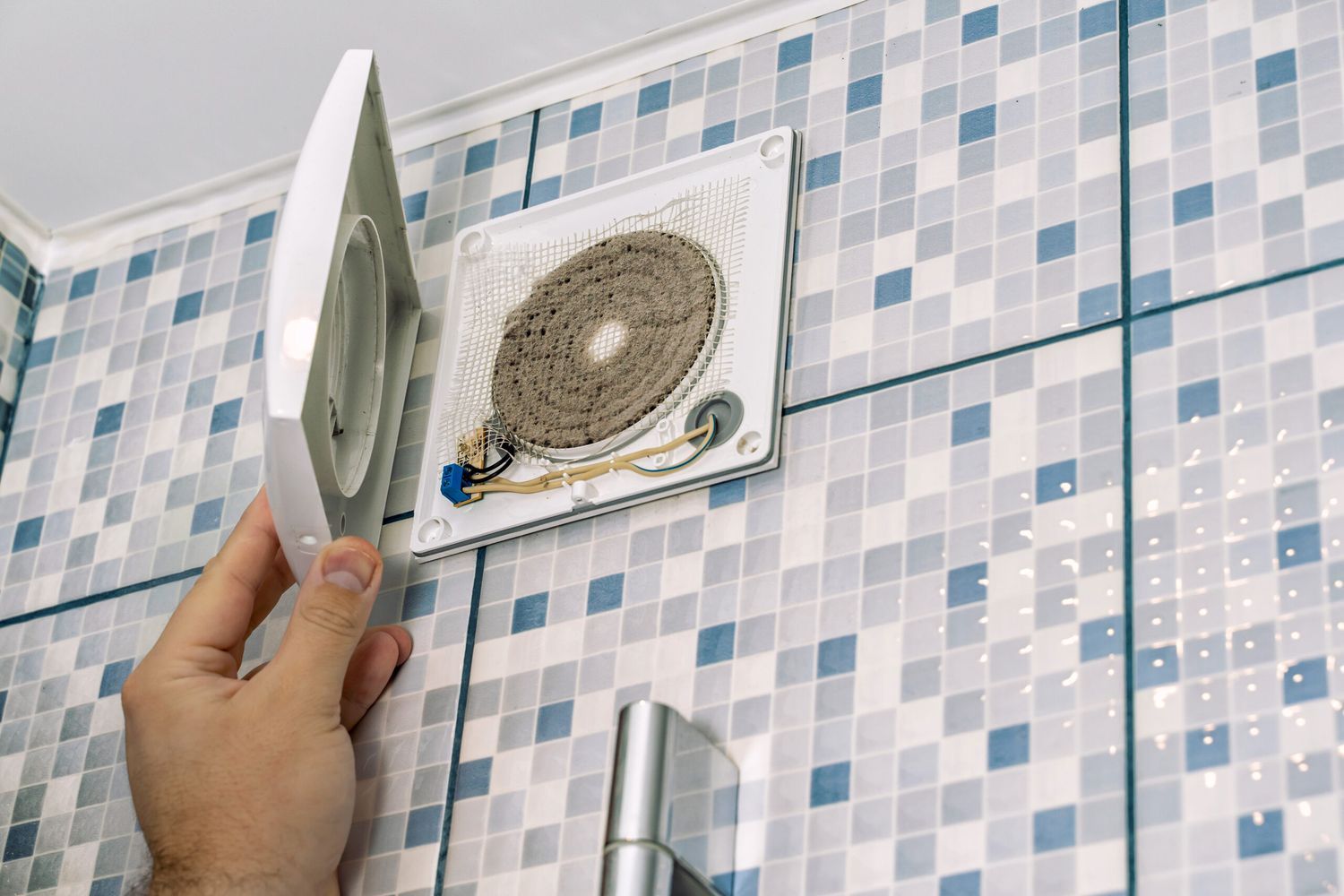 A dirty bathroom exhaust fan that needs cleaning.
