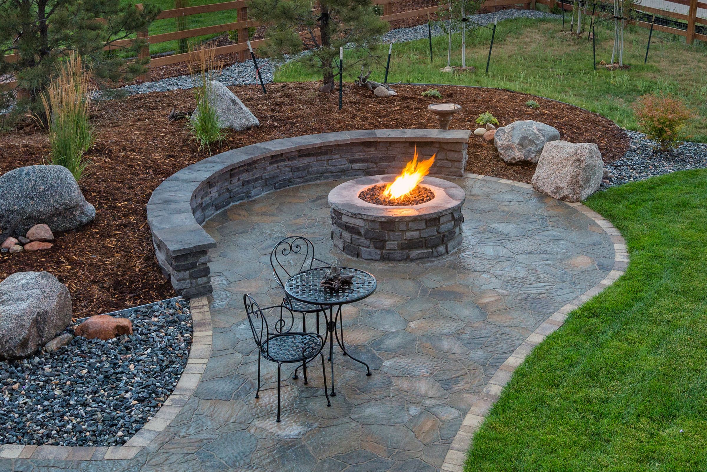 a backyard fire pit with a lit fire