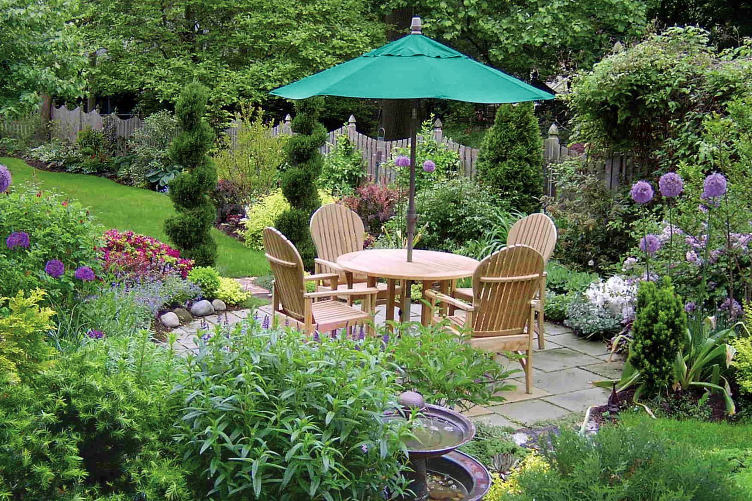 an outdoor patio table surrounded by a garden retreat