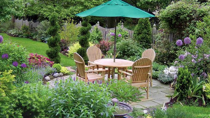 an outdoor patio table surrounded by a garden retreat