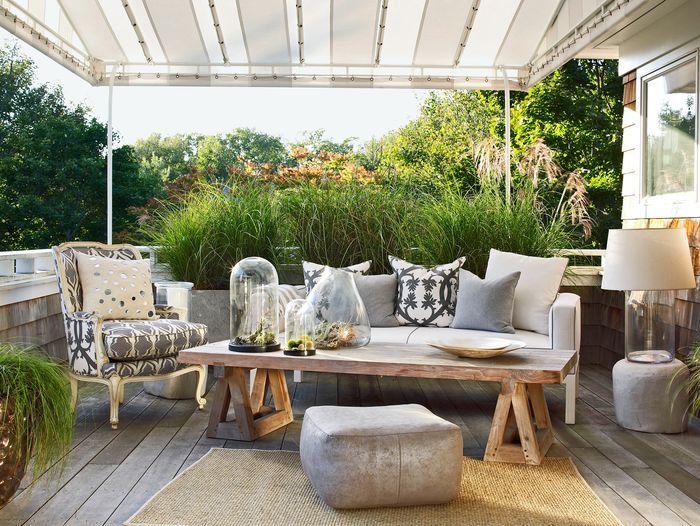 a patio with a canopy over the couch and table