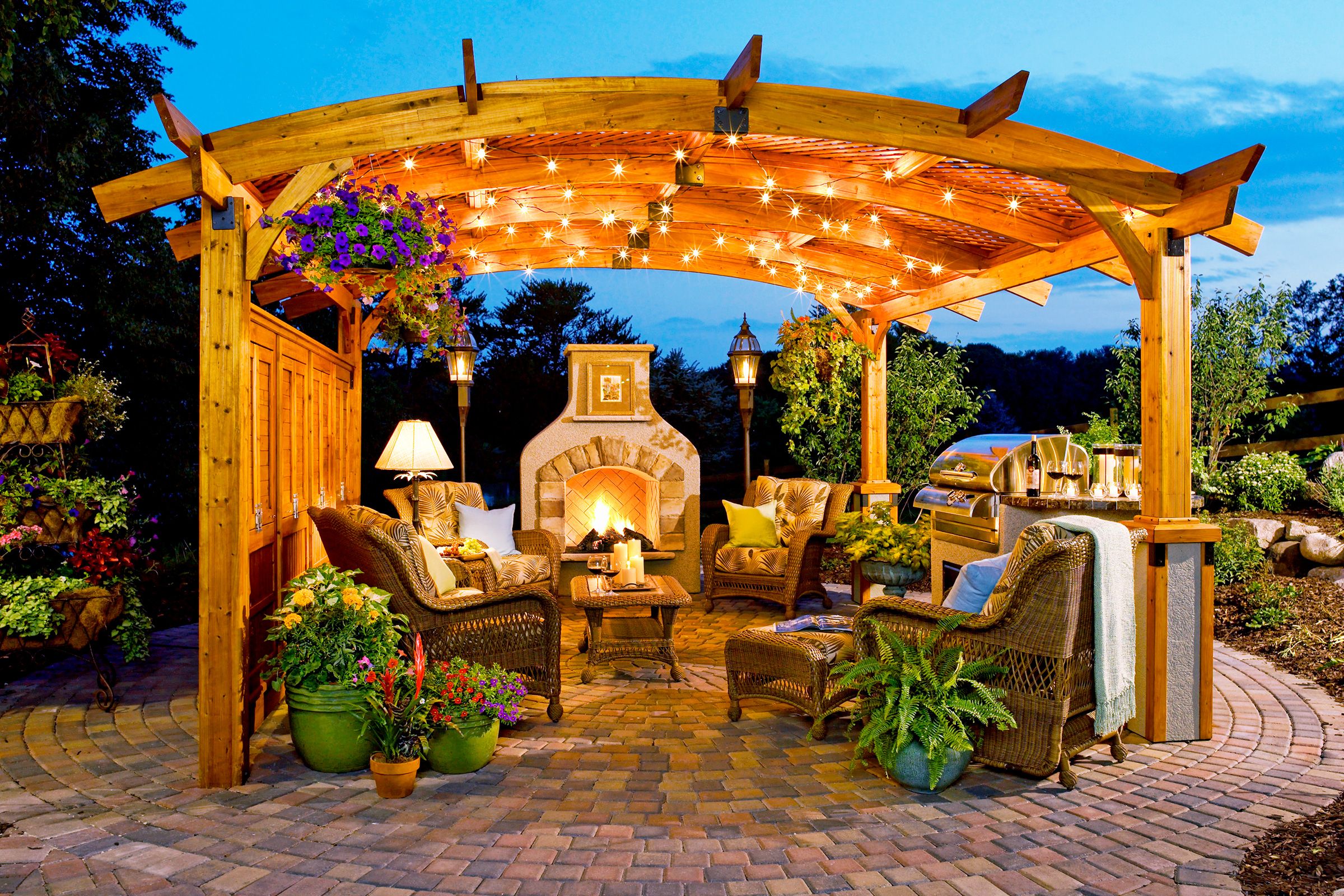 An outdoor kitchen with hanging lighting.