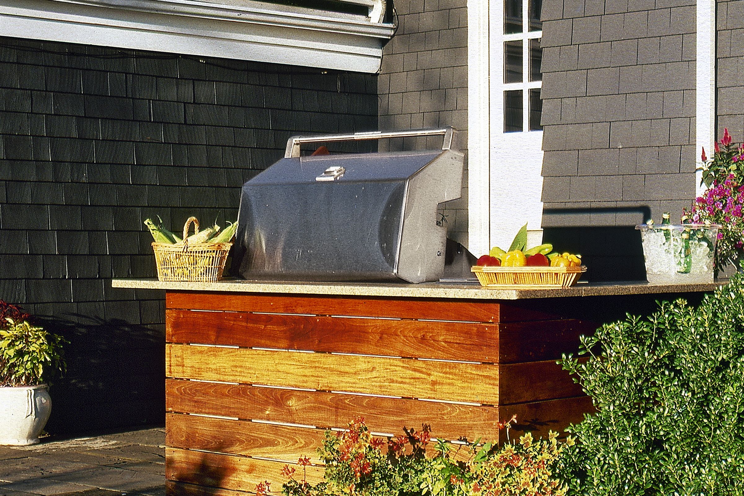 An outdoor kitchen setup near a home.