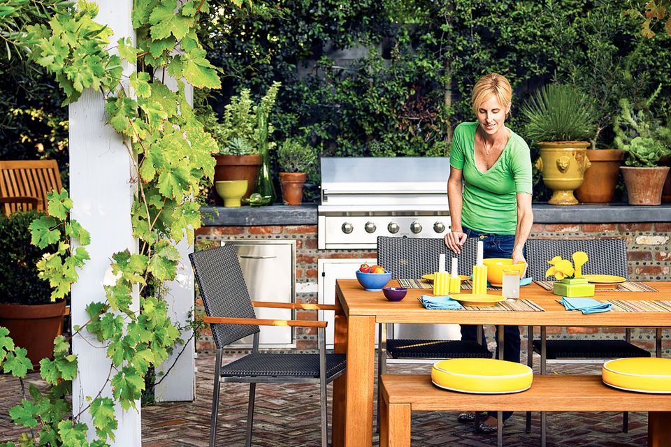 An outdoor kitchen with a dining area.