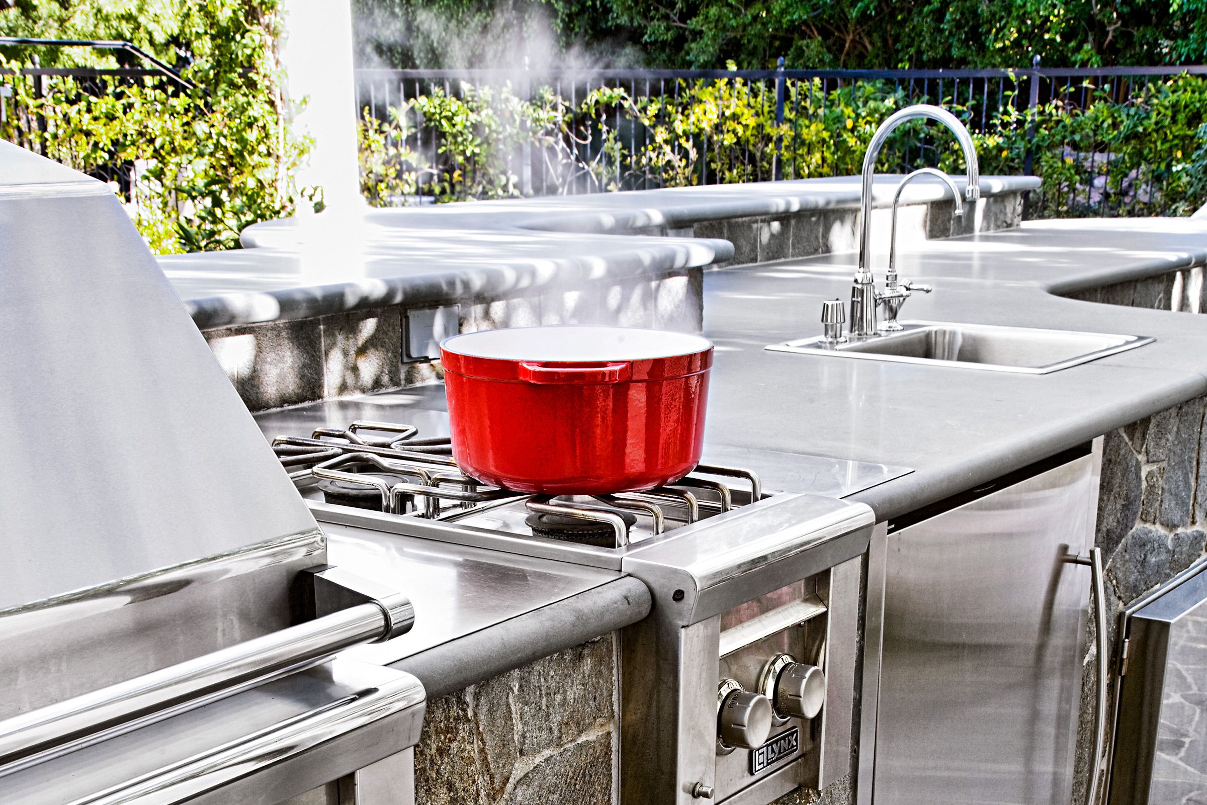 An outdoor kitchen with a sink.