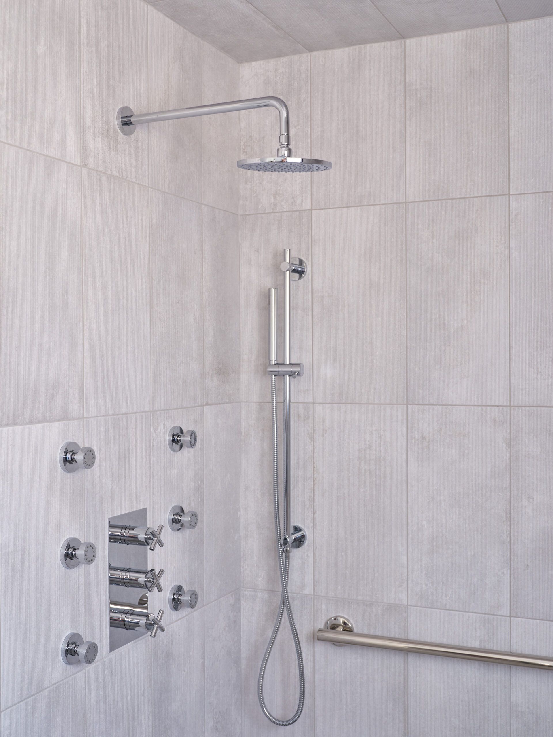 a complete shower system with rainfall showerhead, handheld, and a tower configuration