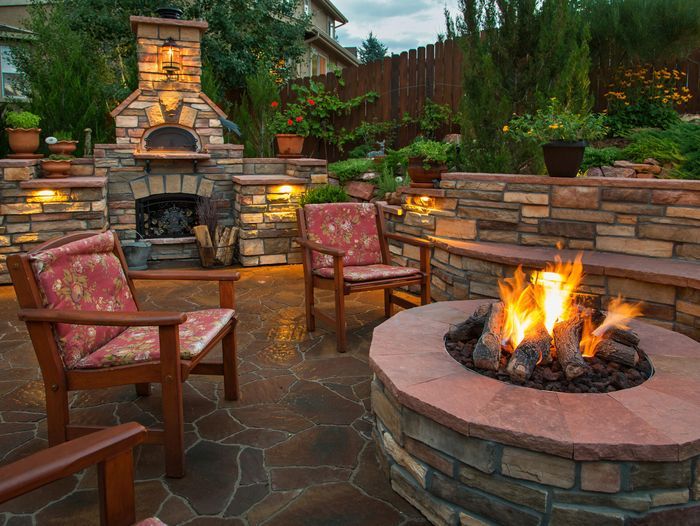 An outdoor fire pit surrounded by chairs.