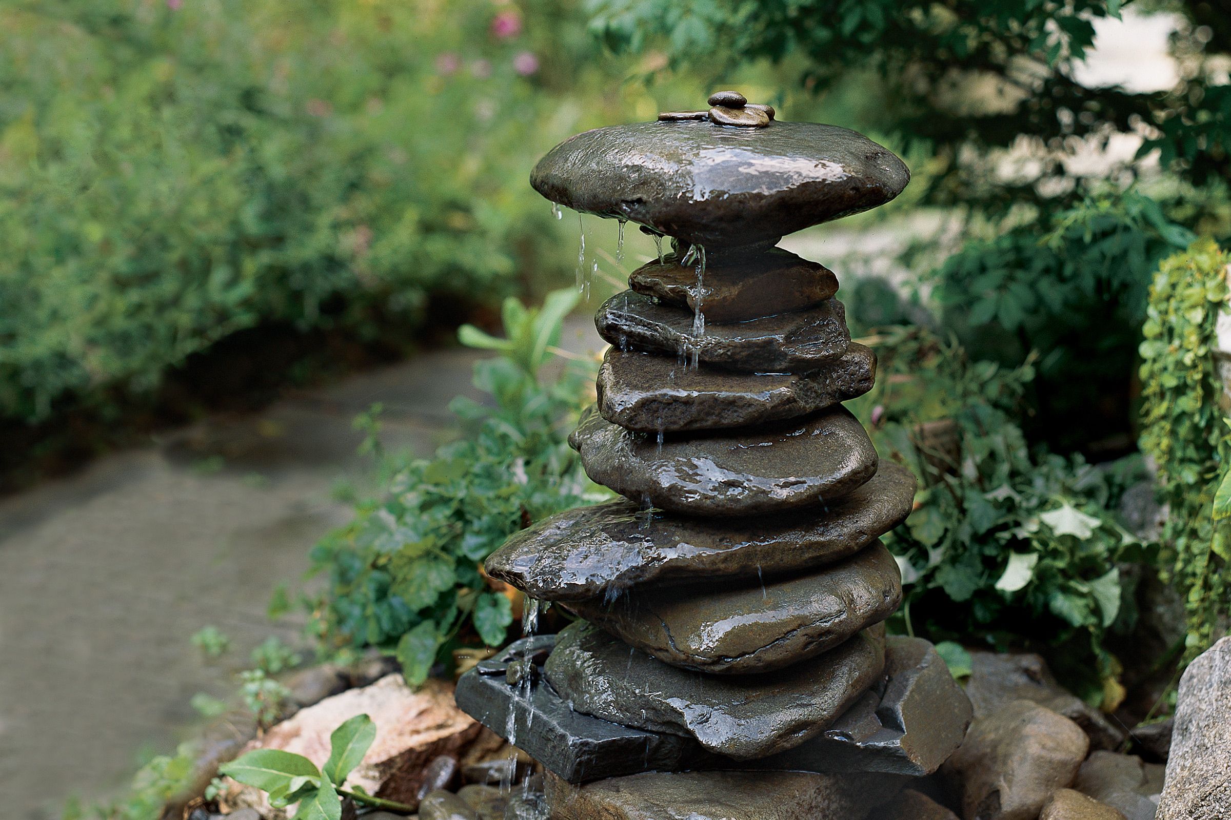 Ornamental fountain built by rocks stacked up on one another. 