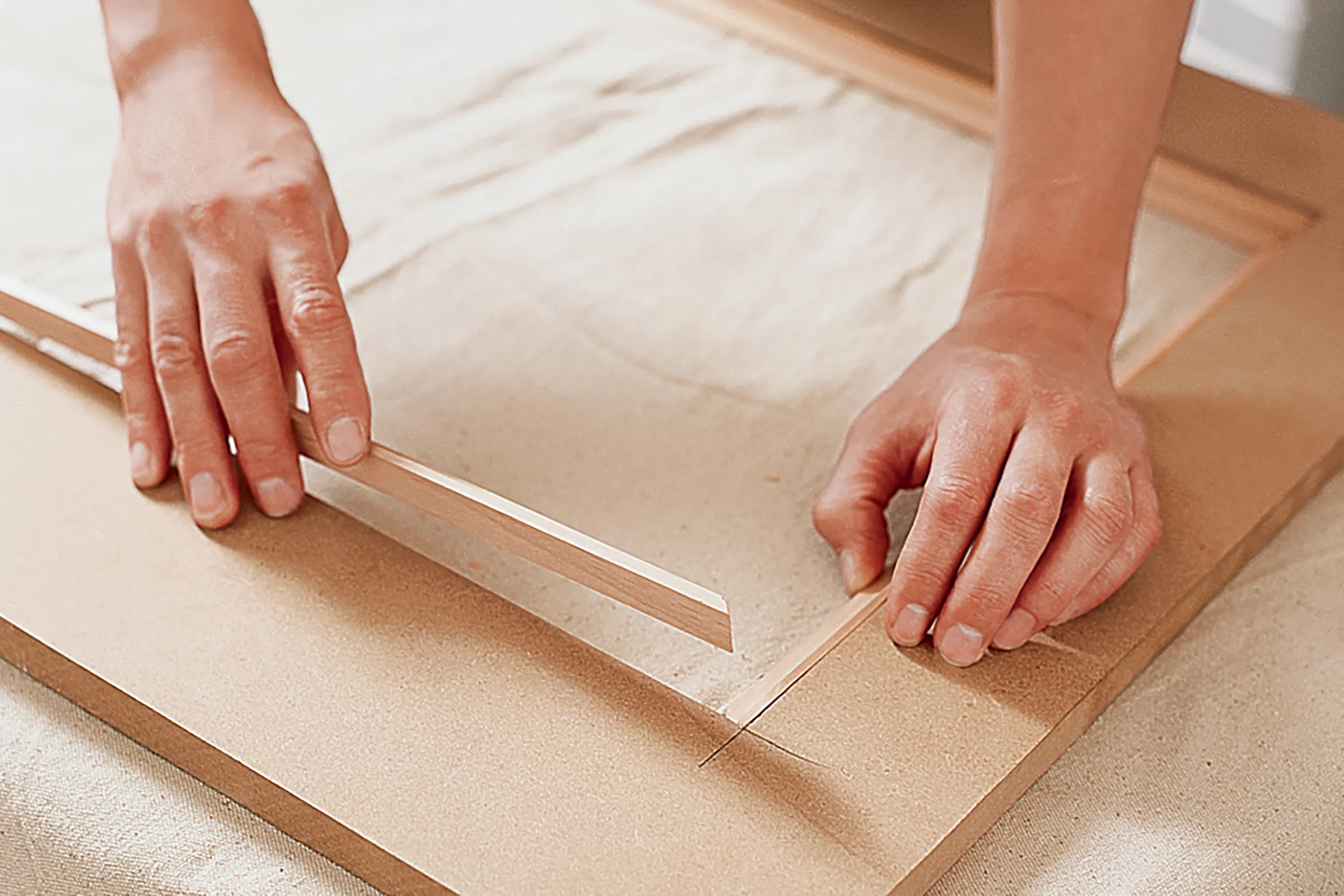 Image of step 2 of the DIY Radiator Cover Cabinet project, which involves fitting the trim to the screen openings
