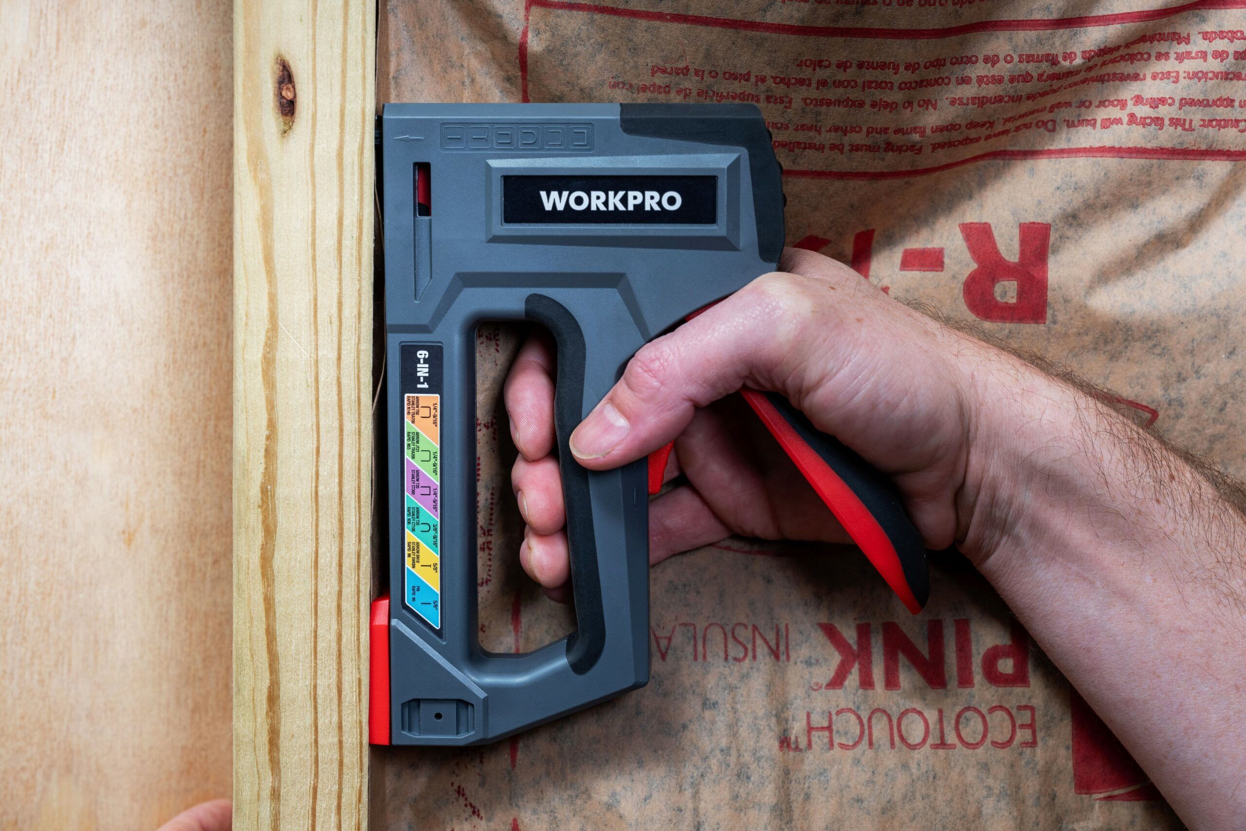 Carpenter using a nail gun to put nails into a new wall Stock Photo - Alamy