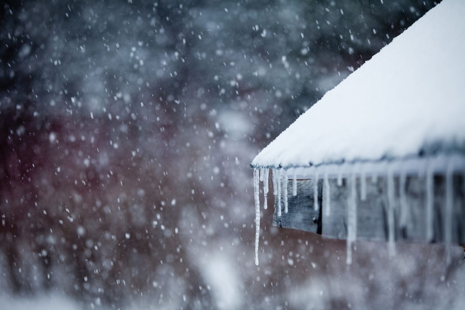 A roof with snow and ice on it in the winter.