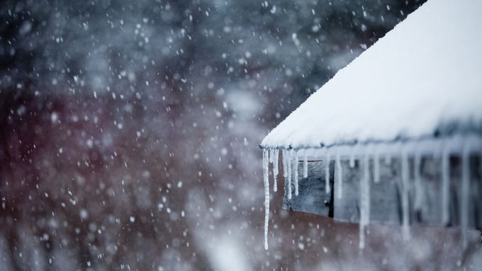 A roof with snow and ice on it in the winter.