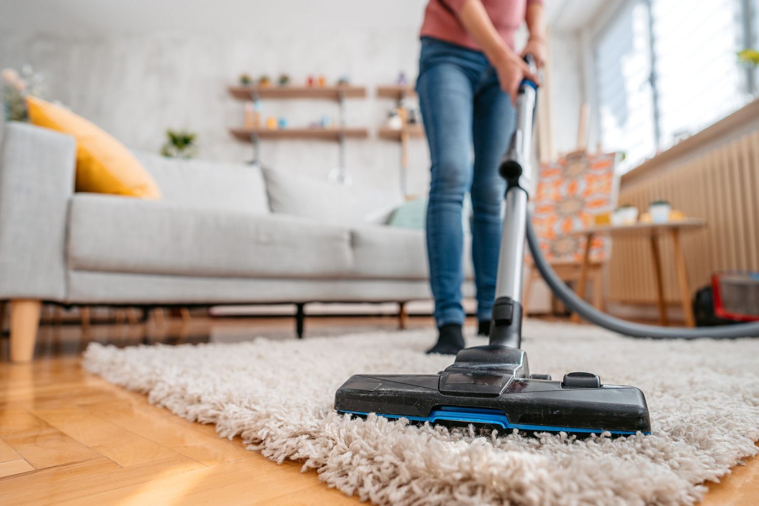 vacuuming dust from a rug