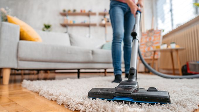 vacuuming dust from a rug