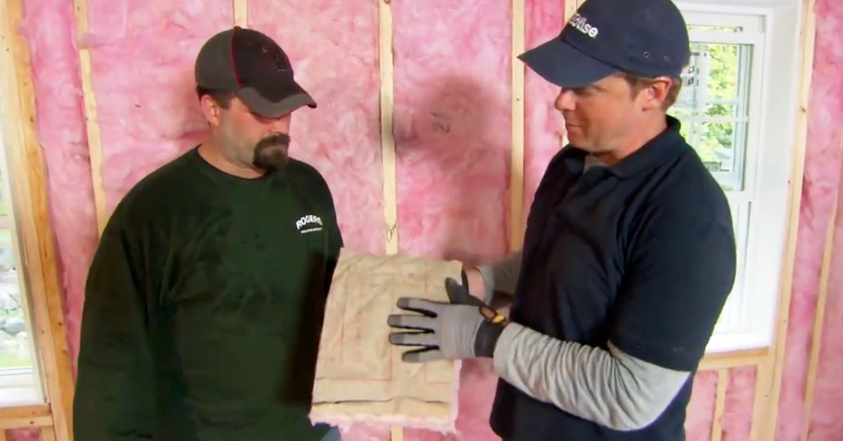 Two men installing fiberglass insulation