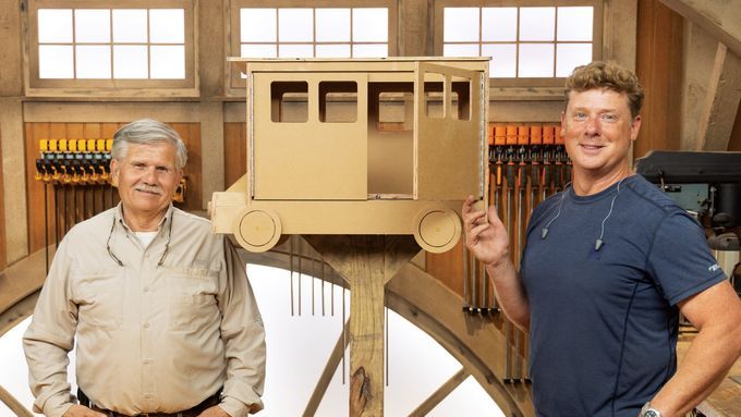 Kevin and Tommy Stand in front of a little free library