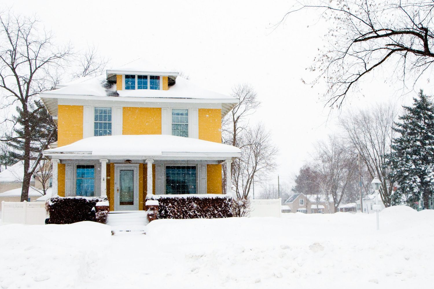 a home that is covered in snow during the winter