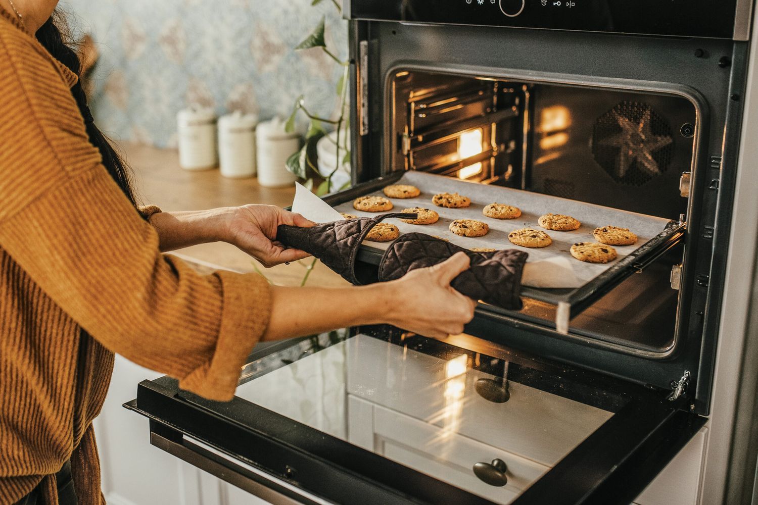 Winter cookies being placed into an oven.