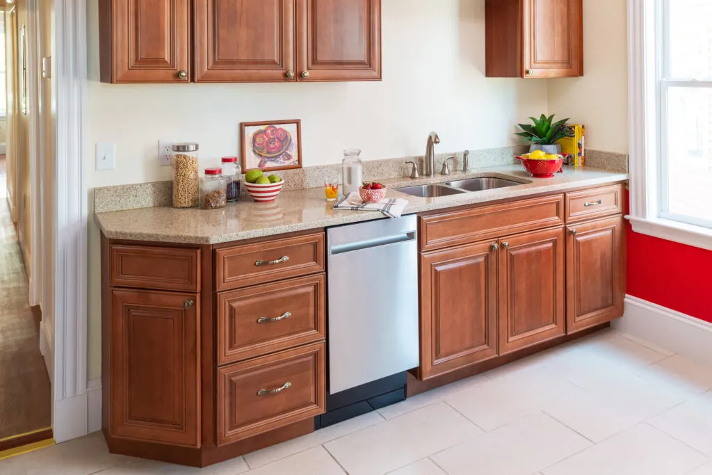 Small kitchen counter with a dishwasher and sink.