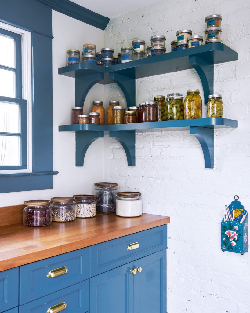 Pantry filled with glass containers full of food and spices