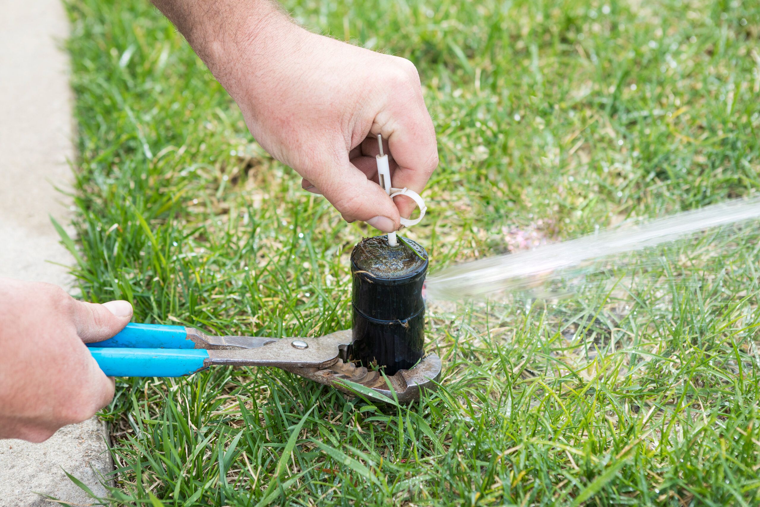 Turning on a sprinkler system with a key and pliers