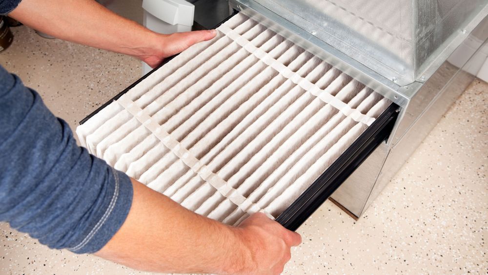 Hands Changing Furnace Air Filter