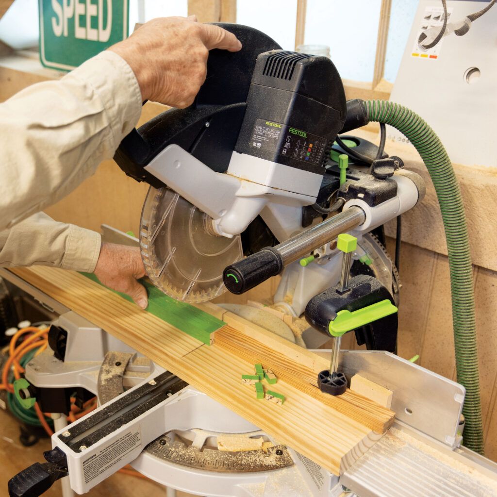 Man cutting with miter saw