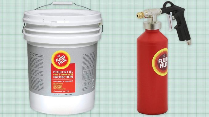 5 gallon tub of Fluid Film and red spray bottle of Fluid film against a green graph paper background. Lead image for best fluid film guide.