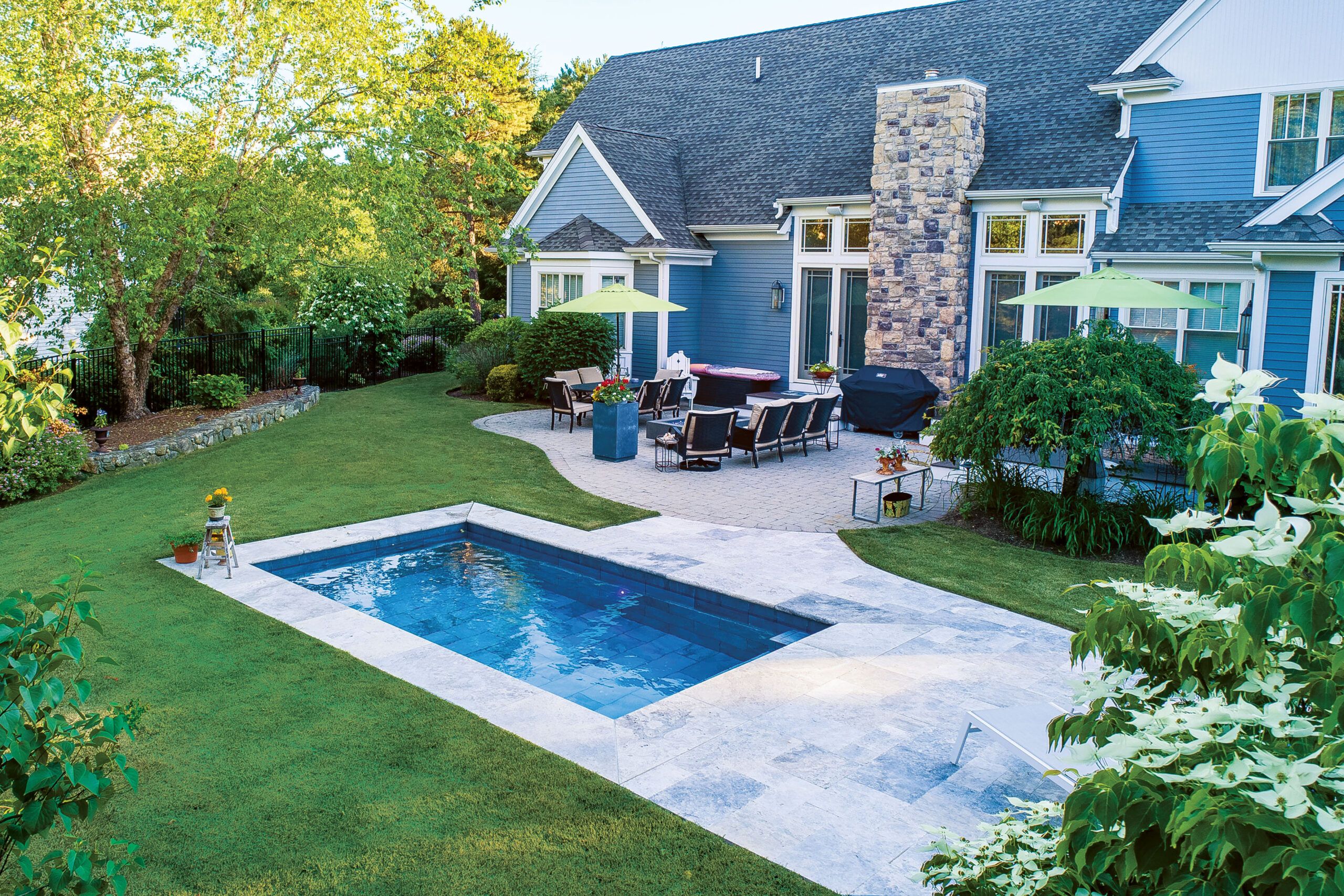 Plunge pool in a grassy back yard