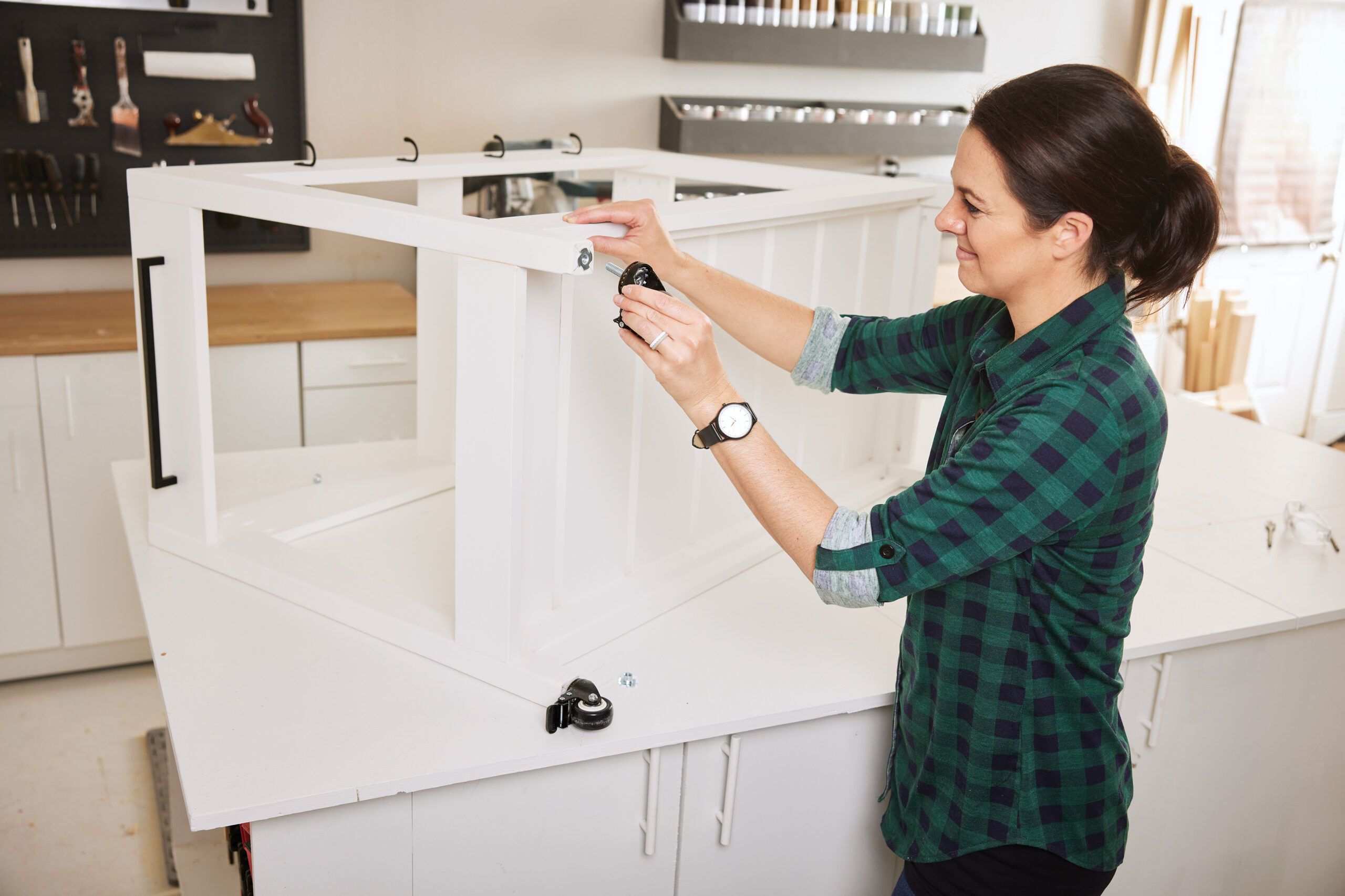 Finish the base, Device, Power Drill, Tool, Easy DIY, Mobile Kitchen Island, Jenn Largesse, TOH, Fall 2023, AAdult, Desk, Female, Furniture, Person, Table, Woman