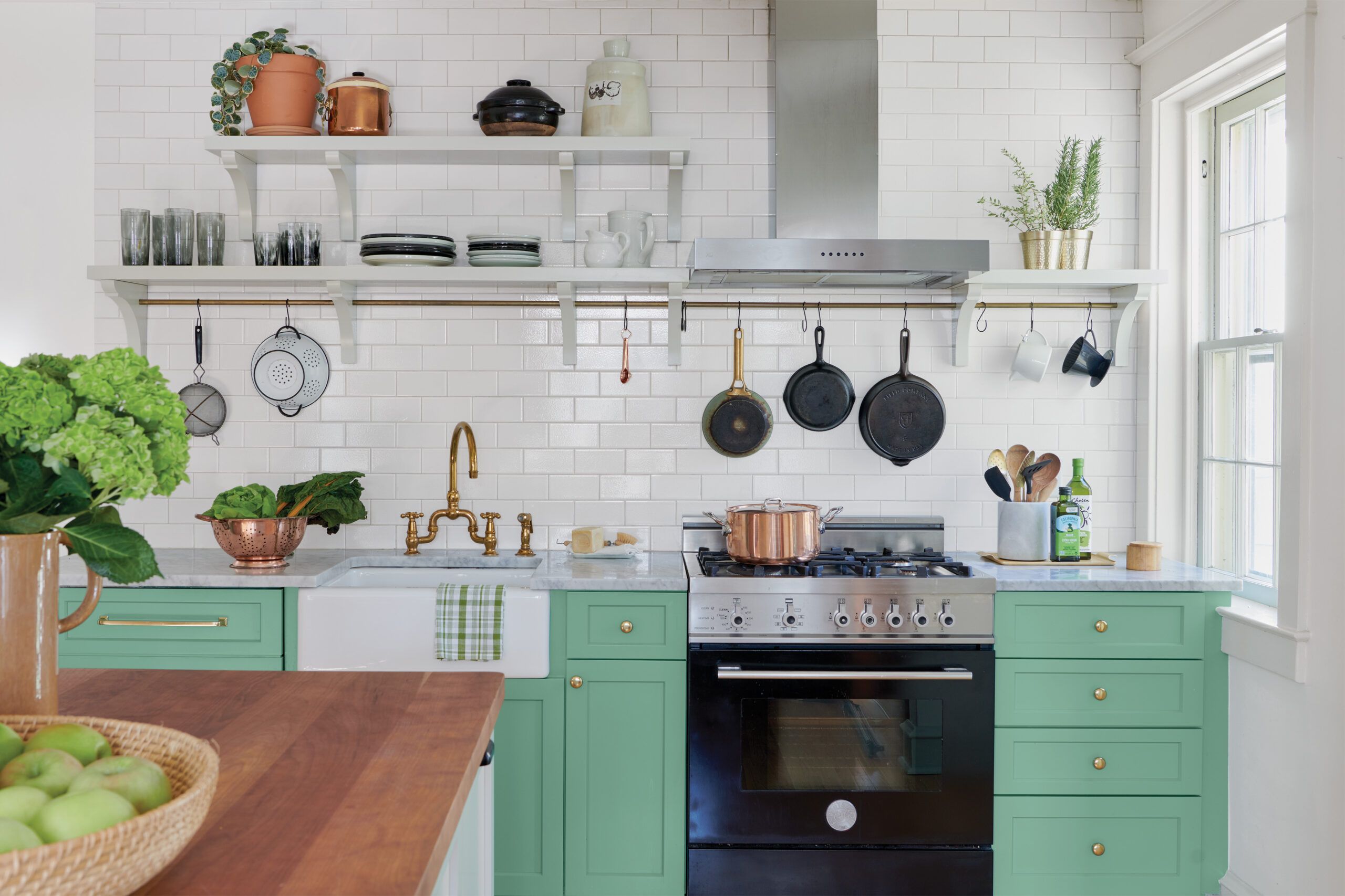 Kitchen with open shelving above the stove and sink