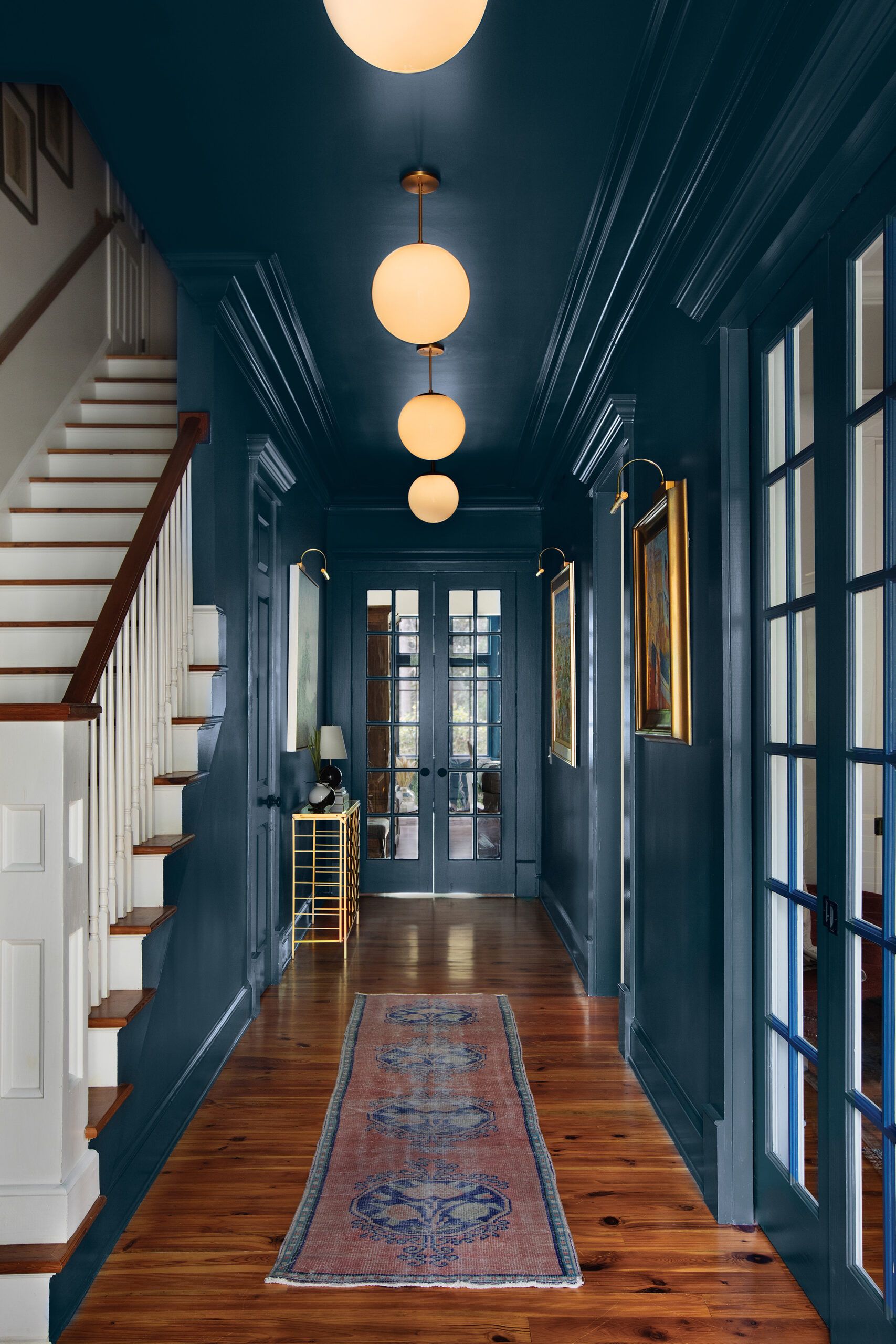 Hallway with the walls trim and doors painted in a dark glossy blue
