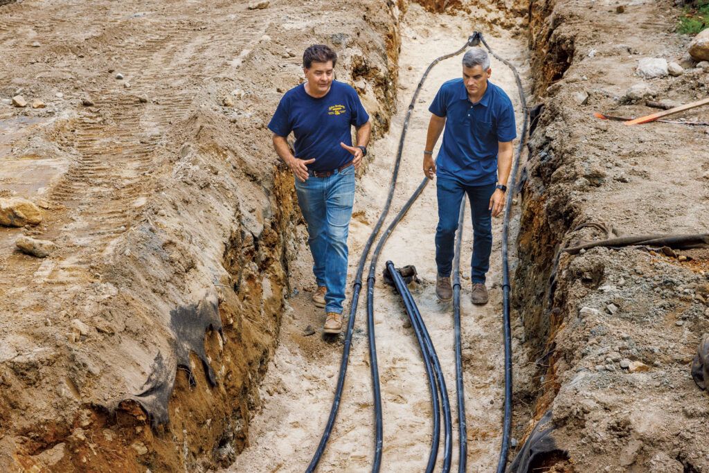 Charlie Silva and Ross Trethewey walking through a geothermal trench