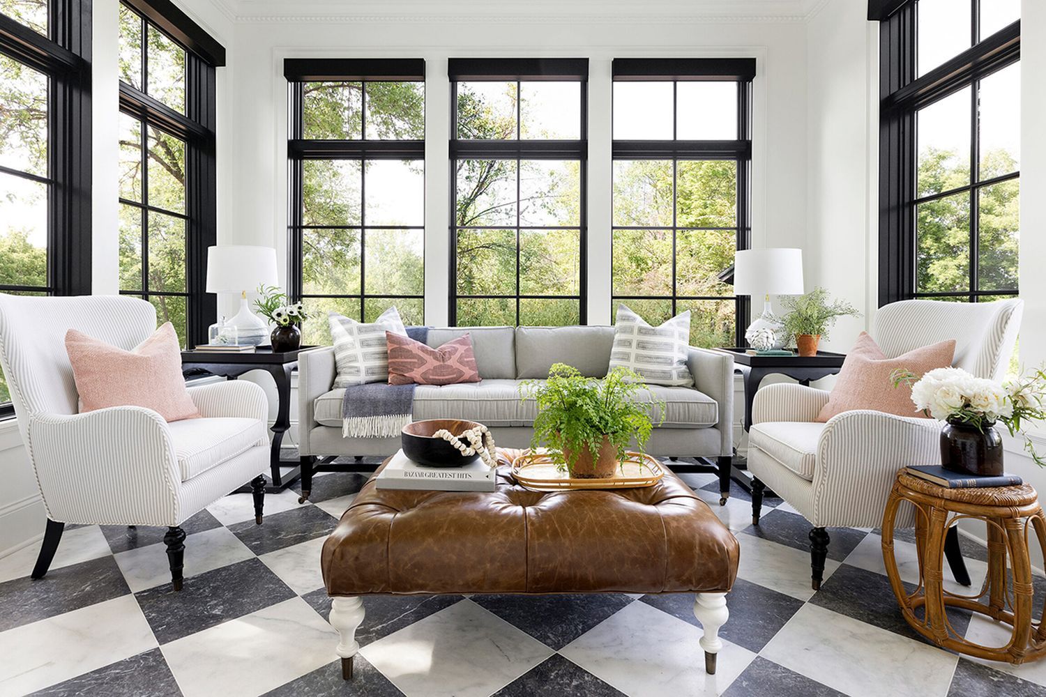 Image of a sunroom that is great for conversations, filled with multiple seating options and decorative tiled floor