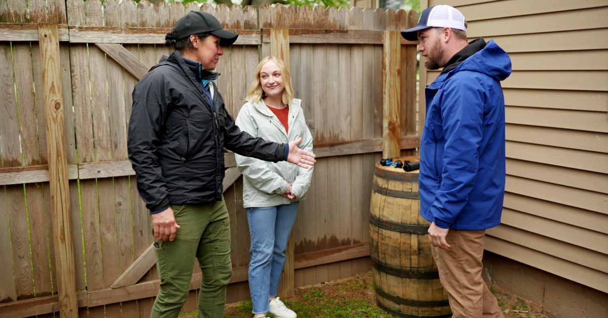 Jenn Nawada and Nathan Gilbert install a rain barrel