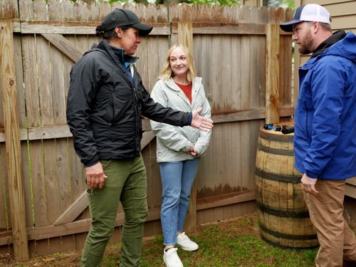 Jenn Nawada and Nathan Gilbert install a rain barrel