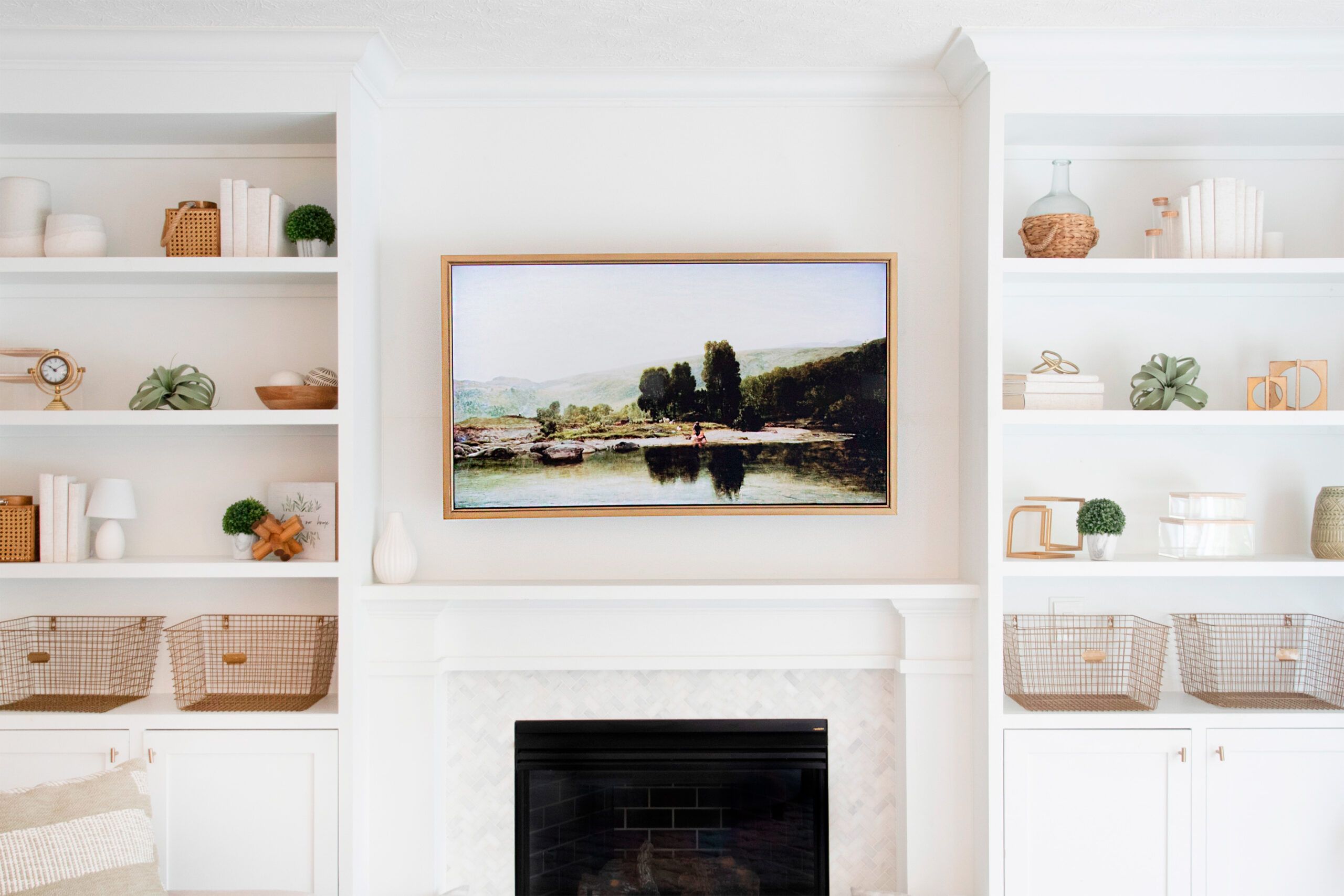 Neutral colored entertainment center with a frame around a TV to make it look like artwork.