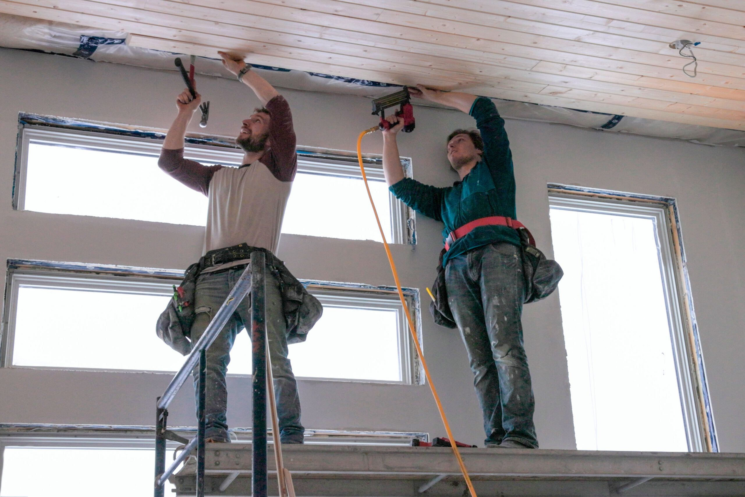 Two men installing a Tongue and Groove Ceiling