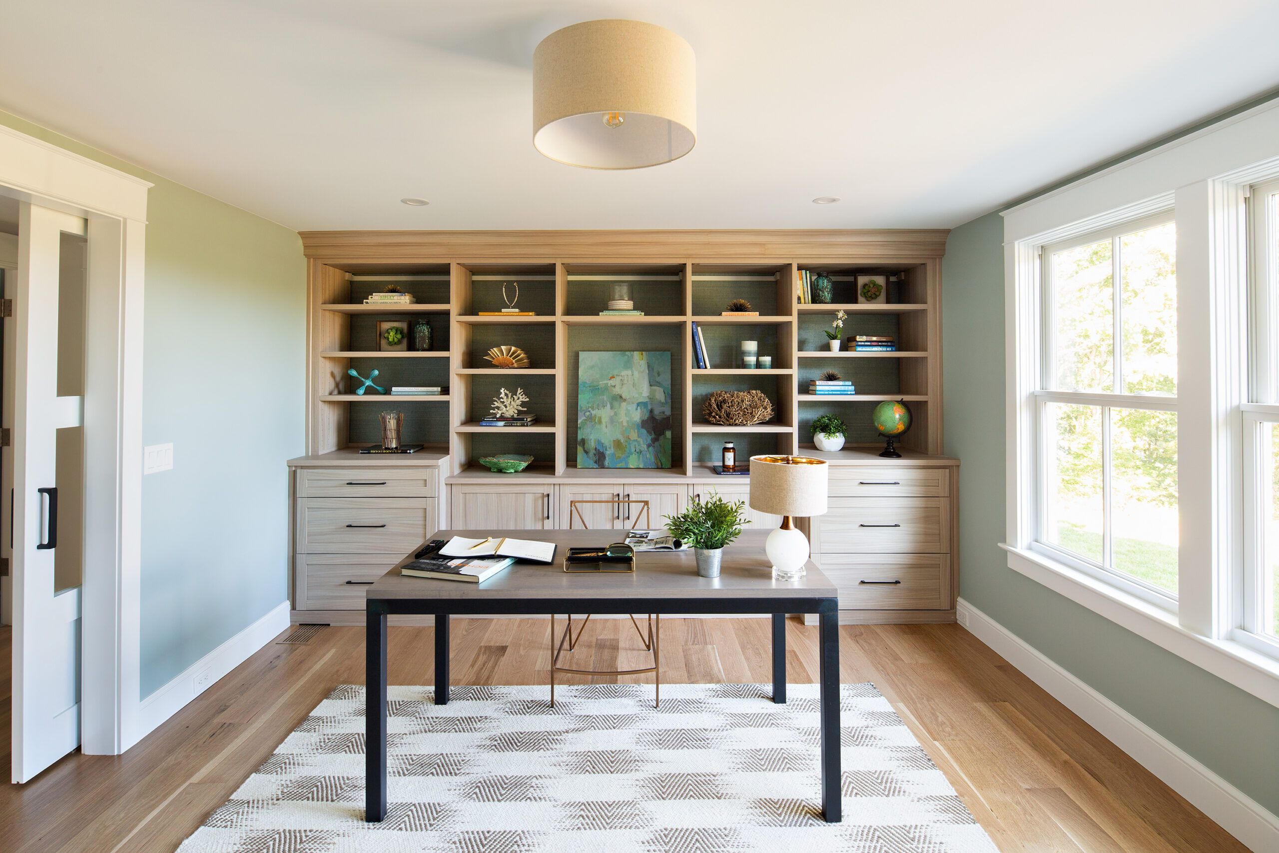 Office with large built in bookcase behind it 