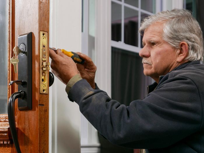 Tom Silva adding a lock to an antique door