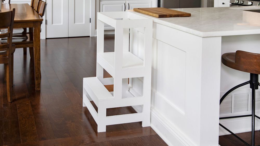 A toddler step stool against a kitchen island