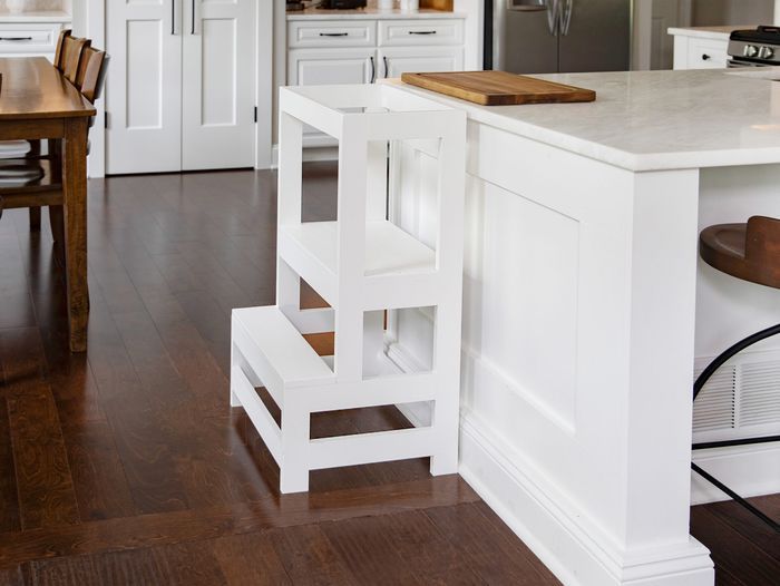 A toddler step stool against a kitchen island