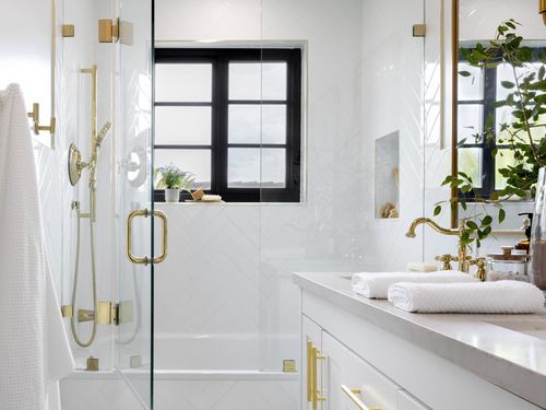 Bathroom renovated by Kathryn Fulton, White with gold accents.